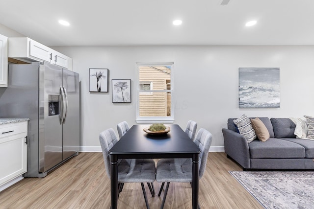 dining area featuring light wood-style flooring, baseboards, and recessed lighting