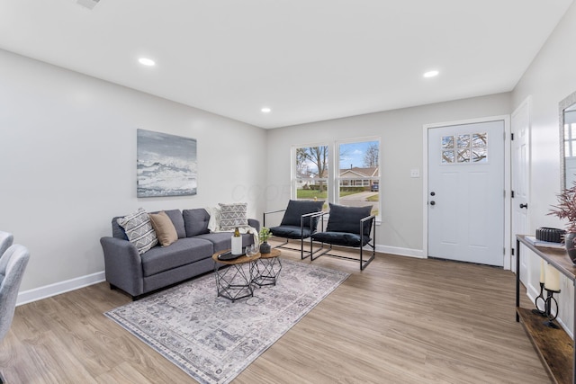 living room with baseboards, light wood-type flooring, and recessed lighting