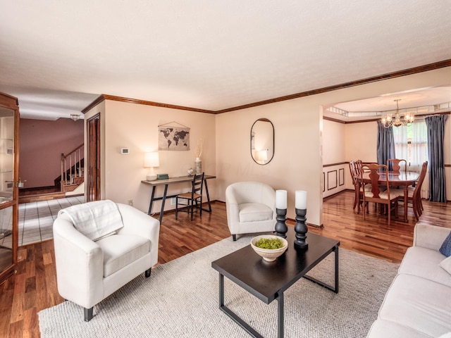 162 Juniper Ave, Westerville, OH 43081 - living room featuring a chandelier, stairs, wood finished floors, and crown molding