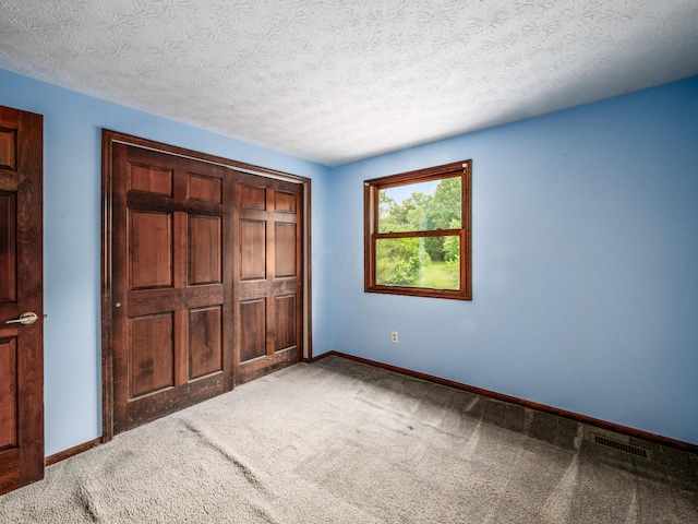 162 Juniper Ave, Westerville, OH 43081 - unfurnished bedroom featuring carpet flooring, a closet, and a textured ceiling