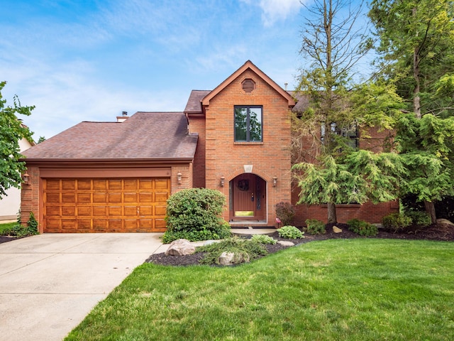 162 Juniper Ave, Westerville, OH 43081 - view of front of property featuring brick siding, a garage, a front yard, concrete driveway, and a shingled roof