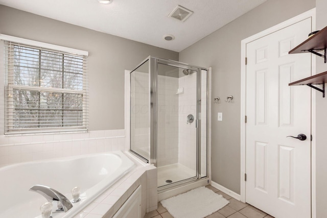 bathroom with a shower stall, visible vents, tile patterned flooring, and a garden tub