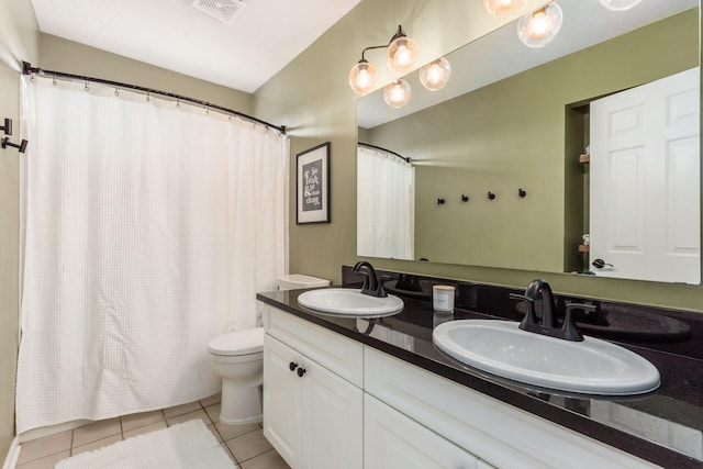 bathroom featuring visible vents, a sink, tile patterned floors, and toilet
