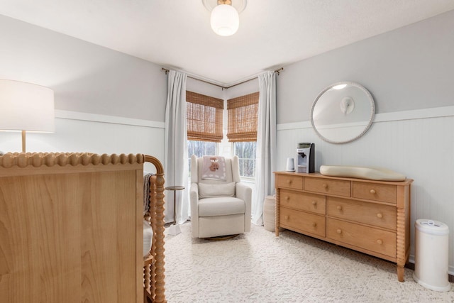 bedroom with a wainscoted wall