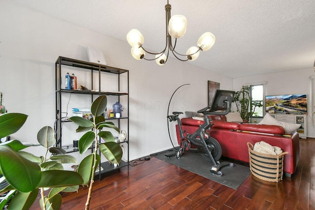 557 Woodingham Pl, Columbus, OH 43213 - workout room with an inviting chandelier, wood finished floors, and a textured ceiling