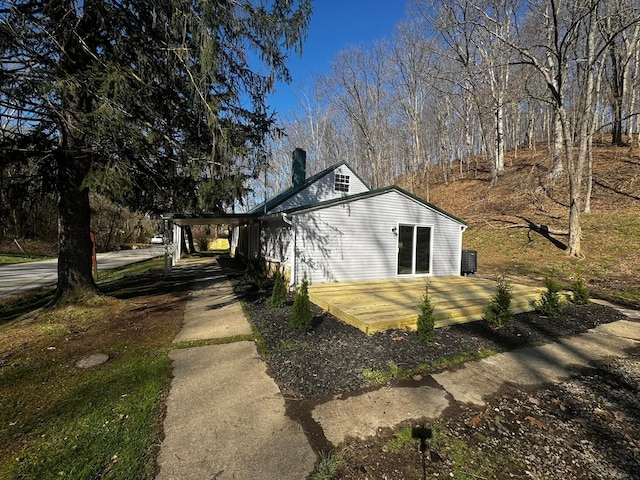 9808 Alderman Rd, Millfield, OH 45761 - view of side of home with an attached carport, driveway, a chimney, and a deck