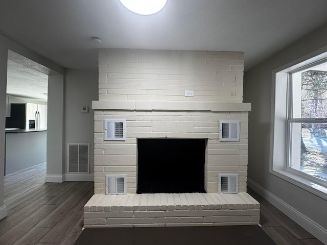 9808 Alderman Rd, Millfield, OH 45761 - details with visible vents, stainless steel fridge, and a fireplace