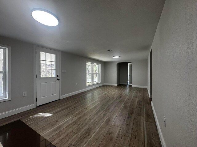 9808 Alderman Rd, Millfield, OH 45761 - entrance foyer featuring dark wood finished floors, baseboards, and arched walkways