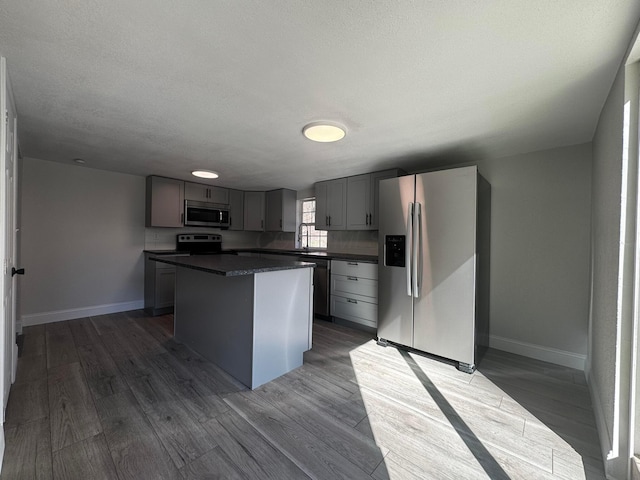 9808 Alderman Rd, Millfield, OH 45761 - kitchen with dark countertops, stainless steel appliances, dark wood-type flooring, and gray cabinets