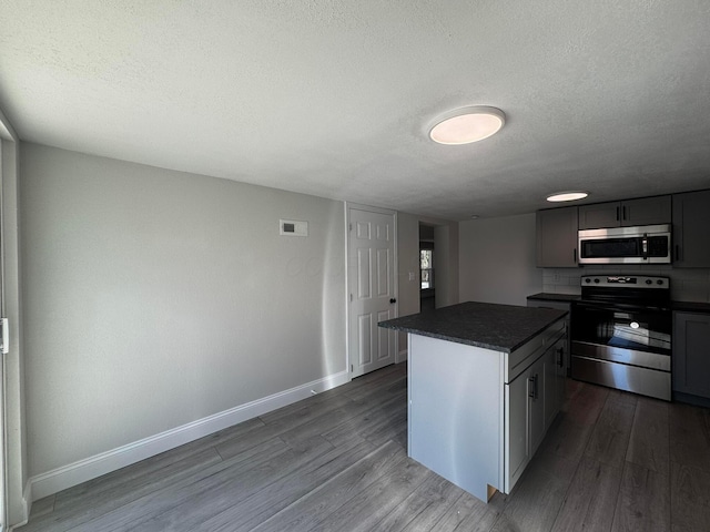 9808 Alderman Rd, Millfield, OH 45761 - kitchen with visible vents, baseboards, dark countertops, appliances with stainless steel finishes, and dark wood-style floors