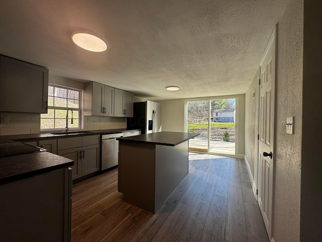 9808 Alderman Rd, Millfield, OH 45761 - kitchen featuring dark wood-style floors, dark countertops, a sink, and stainless steel appliances