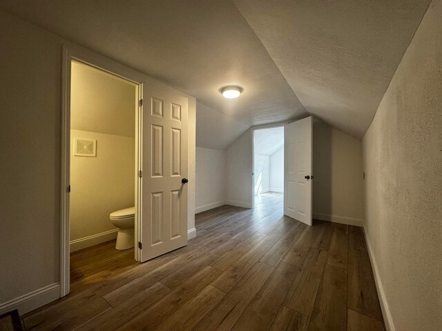 9808 Alderman Rd, Millfield, OH 45761 - bonus room with baseboards, lofted ceiling, a textured ceiling, and hardwood / wood-style flooring