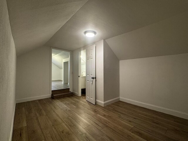 9808 Alderman Rd, Millfield, OH 45761 - additional living space featuring baseboards, a textured ceiling, and dark wood finished floors