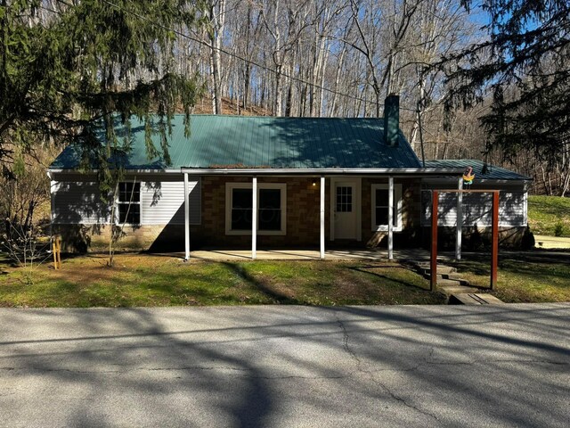 9808 Alderman Rd, Millfield, OH 45761 - exterior space with metal roof, a chimney, and a standing seam roof