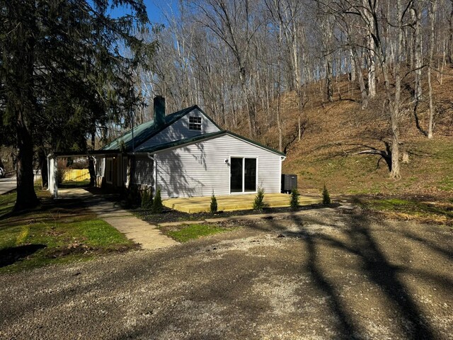 9808 Alderman Rd, Millfield, OH 45761 - view of side of home with dirt driveway and a chimney