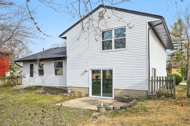 back of house with a patio, a shingled roof, fence, and a yard