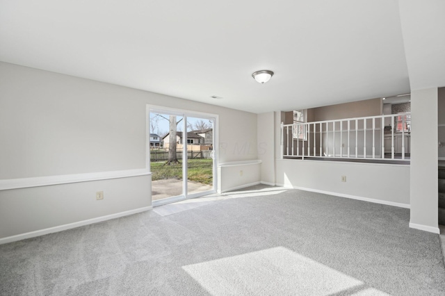 carpeted spare room featuring baseboards