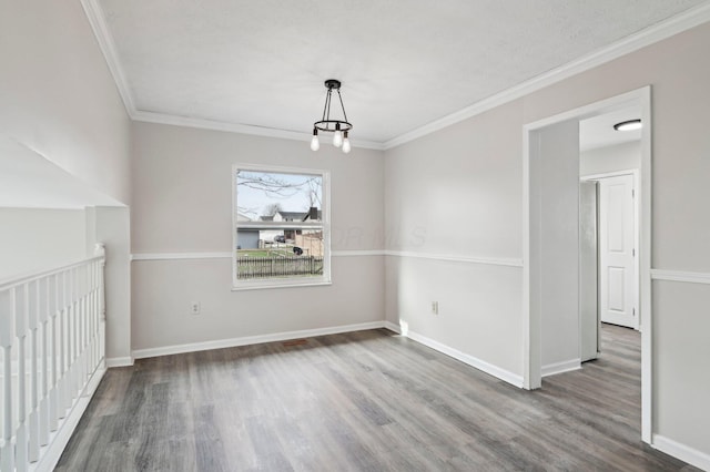 unfurnished dining area with baseboards, wood finished floors, an inviting chandelier, and crown molding