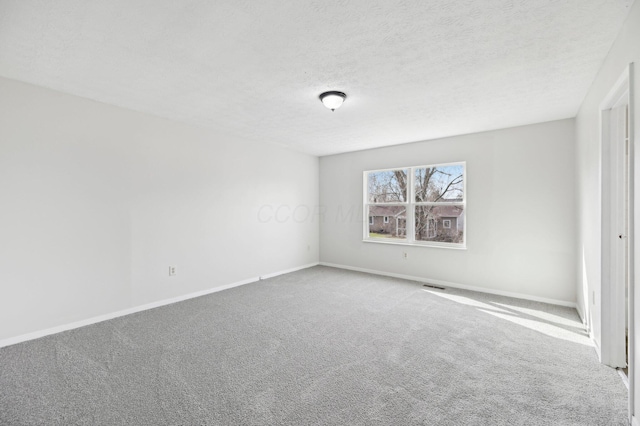 unfurnished bedroom featuring baseboards, visible vents, carpet flooring, and a textured ceiling