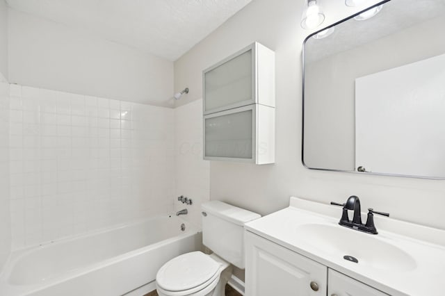 full bath with  shower combination, toilet, vanity, and a textured ceiling