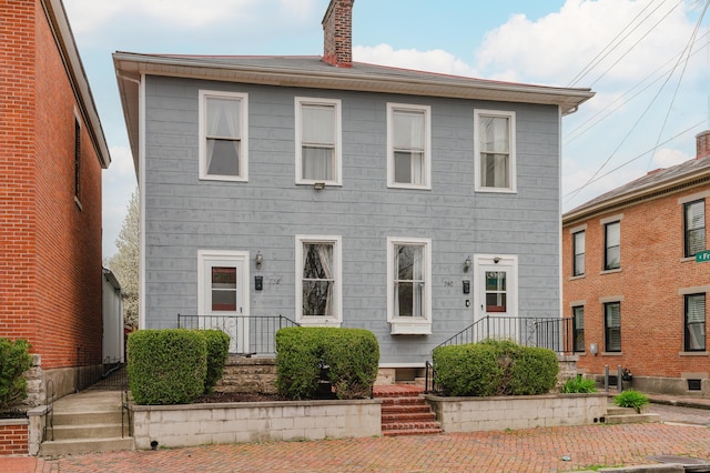 colonial home featuring a chimney