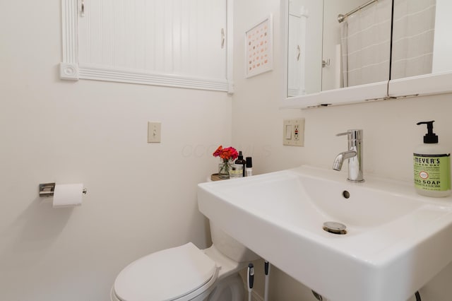 bathroom with toilet and a sink