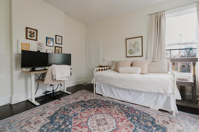 bedroom featuring baseboards and wood finished floors