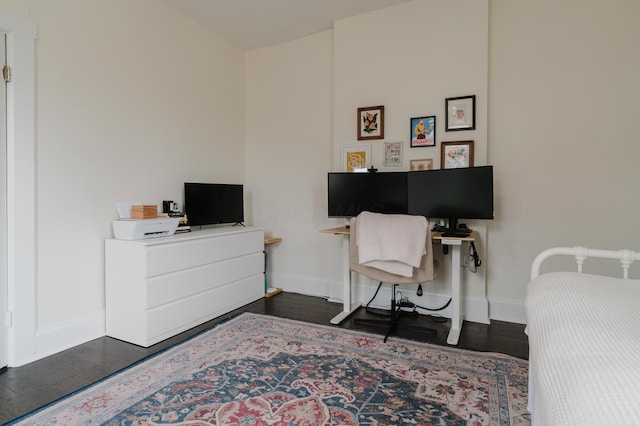 bedroom with baseboards and dark wood finished floors