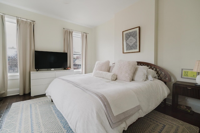 bedroom featuring dark wood-style flooring