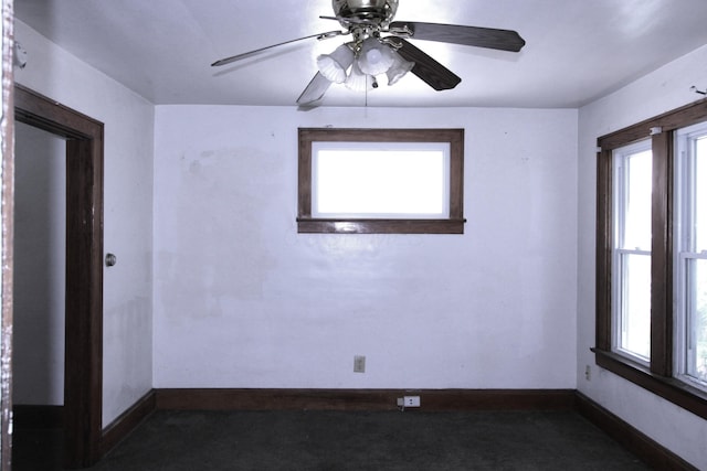 1256 S Champion Ave, Columbus, OH 43206 - empty room with baseboards, a ceiling fan, and dark colored carpet