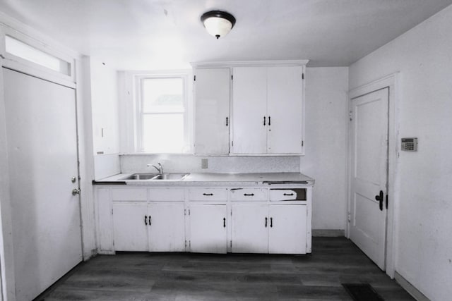 1256 S Champion Ave, Columbus, OH 43206 - kitchen featuring a sink, white cabinetry, light countertops, and dark wood-type flooring