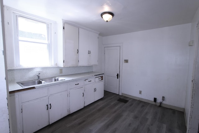 1256 S Champion Ave, Columbus, OH 43206 - kitchen featuring a sink, white cabinetry, wood finished floors, light countertops, and baseboards