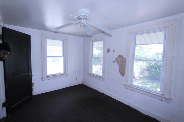 1256 S Champion Ave, Columbus, OH 43206 - unfurnished room featuring baseboards, plenty of natural light, ceiling fan, and dark carpet