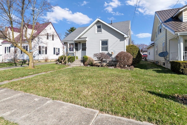 bungalow-style home with a front lawn