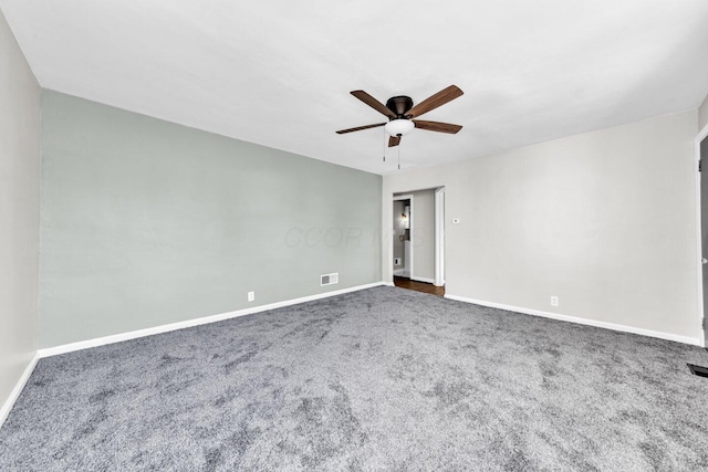 unfurnished room with carpet, baseboards, ceiling fan, and visible vents