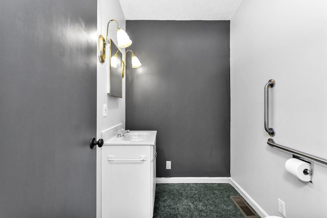 bathroom with baseboards, visible vents, and vanity
