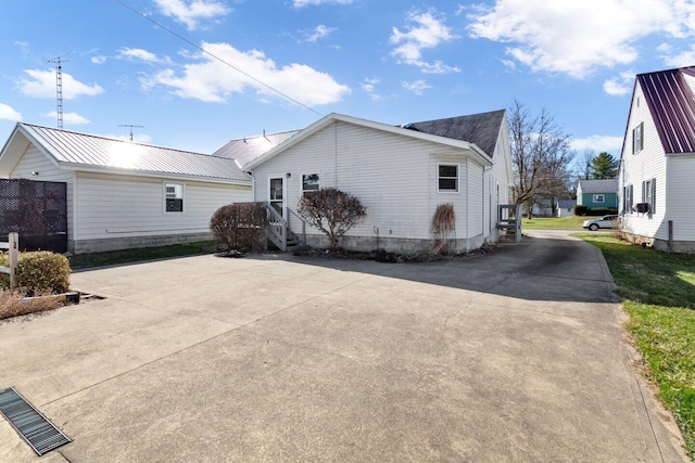 view of side of property with driveway and entry steps