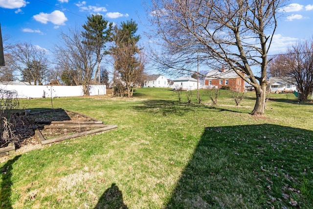 view of yard with fence and a vegetable garden