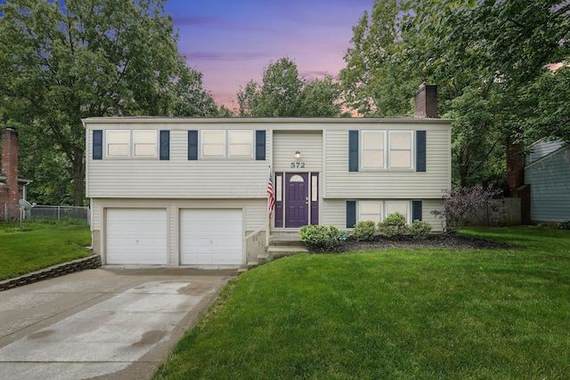 572 Sycamore Dr, Pickerington, OH 43147 - bi-level home featuring a chimney, an attached garage, and concrete driveway