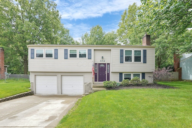 572 Sycamore Dr, Pickerington, OH 43147 - bi-level home featuring an attached garage, a chimney, and driveway