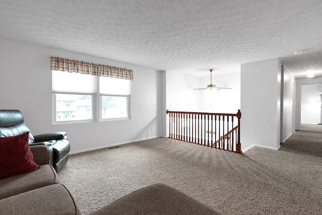 572 Sycamore Dr, Pickerington, OH 43147 - sitting room with carpet flooring, a textured ceiling, baseboards, ceiling fan, and an upstairs landing