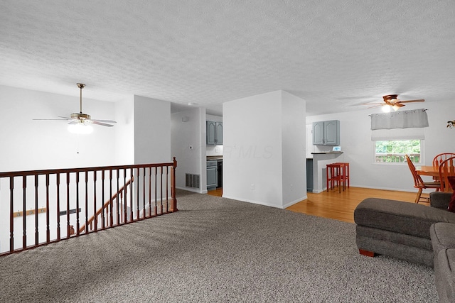 572 Sycamore Dr, Pickerington, OH 43147 - living room with a ceiling fan, a textured ceiling, light carpet, and baseboards
