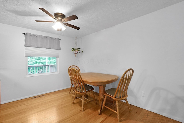 572 Sycamore Dr, Pickerington, OH 43147 - dining room with wood finished floors, baseboards, a ceiling fan, and a textured ceiling