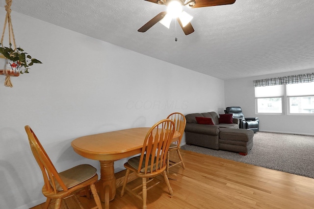 572 Sycamore Dr, Pickerington, OH 43147 - dining space featuring a textured ceiling, light wood-style floors, and a ceiling fan