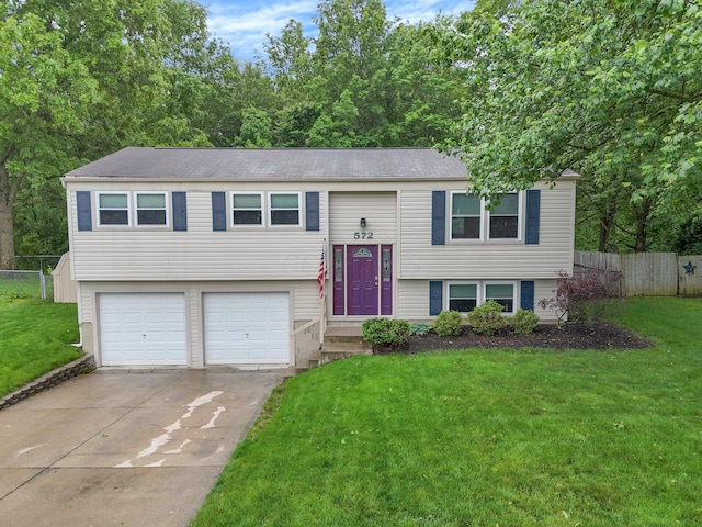 572 Sycamore Dr, Pickerington, OH 43147 - split foyer home featuring an attached garage, concrete driveway, and a shingled roof