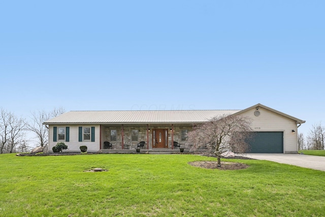 single story home featuring an attached garage, covered porch, metal roof, a front lawn, and driveway
