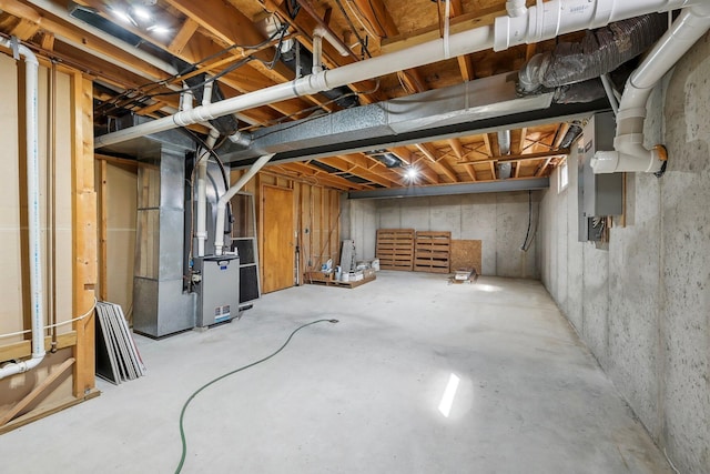 unfinished basement featuring heating unit