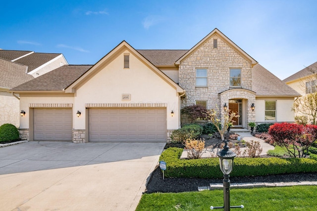 4568 Hickory Rock Dr, Powell, OH 43065 - view of property with stucco siding, driveway, stone siding, and a garage