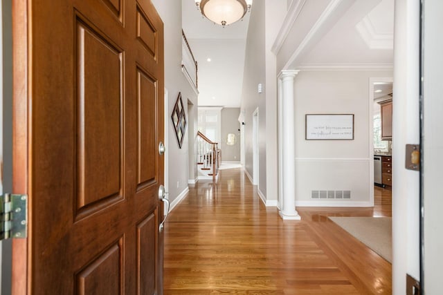 4568 Hickory Rock Dr, Powell, OH 43065 - foyer with light wood-type flooring, decorative columns, visible vents, and a healthy amount of sunlight