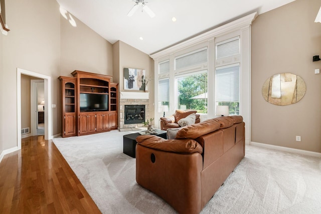 4568 Hickory Rock Dr, Powell, OH 43065 - living room featuring light wood-style floors, a fireplace, high vaulted ceiling, a ceiling fan, and baseboards